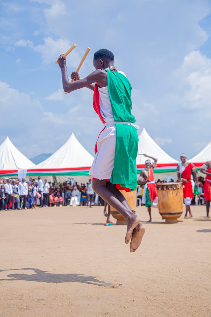 Vibrant traditional dance and drumming performance at an outdoor cultural festival.